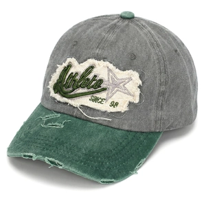 Detail showing vintage washed cotton baseball cap with Athlete embroidery and worn edges