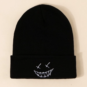 Classic black knitted beanie featuring white embroidered funny face with folded cuff