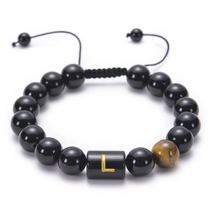 Close-up of adjustable braided bracelet with obsidian beads, tiger eye and gold letter L