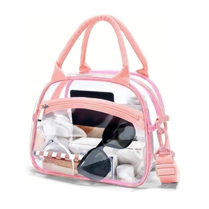 Close-up of a pink transparent PVC waterproof toiletry bag with adjustable shoulder strap