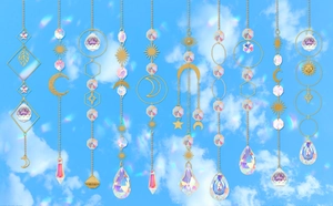 Detail of crystal suncatchers with gold moon and star prisms against a blue sky