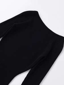 Detailed view of the black ribbed knit fabric and elegant wide neckline of the midi dress