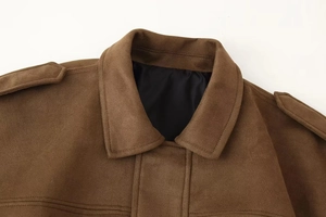 Close-up of brown faux suede bomber jacket collar with shoulder straps and stitching