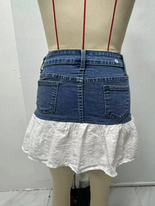 Detail view of denim mini skirt with white lace embroidery hem and back pockets