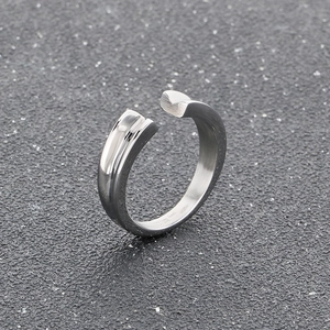 Macro shot of silver stainless steel ring featuring a sleek V-groove and matte finish