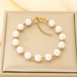 Detail view of elegant pearl bracelet with gold metal beads and adjustable lobster clasp