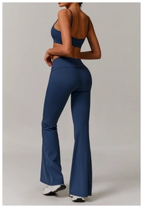 Detail view of high-waist yoga flared pants and ribbed tank top in deep blue color