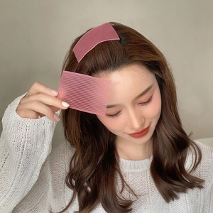 Pink rectangular hair pads for fringe styling shown on a model with knitwear background