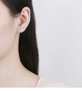 Detailed close-up of 925 sterling silver angel wing stud earring with sparkling cubic zirconia
