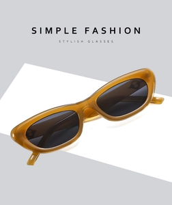 Detail view of amber translucent cat-eye sunglasses with dark polarized lenses