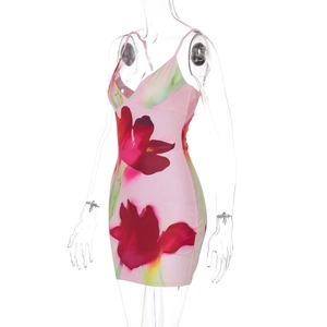 Detail of pink floral mini dress with red and yellow flowers and V-neckline design