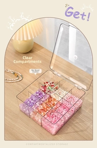 Close-up of clear 9-compartment acrylic storage box with colorful jewelry beads