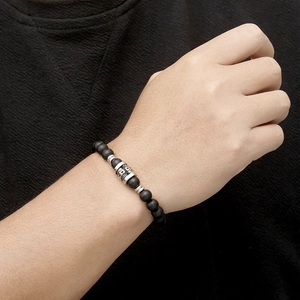 Tiger eye and onyx beaded bracelet with vintage steel skull on a male wrist