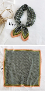 Detail of silk square scarf featuring green and peach floral patterns with styling layout
