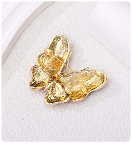 Macro detail of butterfly brooch back with gold plating and secure pin closure