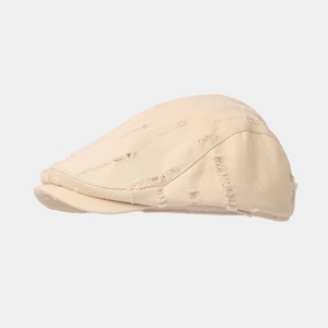 Side view of beige ivy cap with distressed ripped details and vintage canvas texture