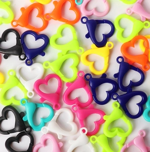 Close-up of assorted colorful heart-shaped acrylic lobster clasps for DIY jewelry making