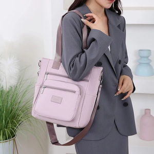 Pink oxford cloth shoulder bag for women with multi-zipper pockets and wide strap