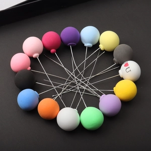 Macro shot of colorful clay balloon cake toppers in various matte finishes
