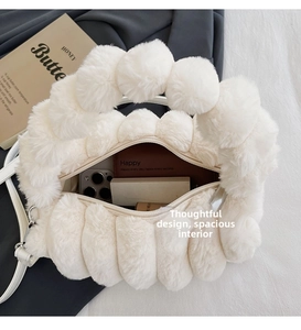 Close-up of white plush handbag showing large interior space and fluffy texture