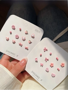 Detail of pink floral and heart stud earrings set with S925 silver needles