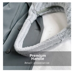 Detail view of the wide fuzzy plush handle and metal zipper on grey faux fur tote bag
