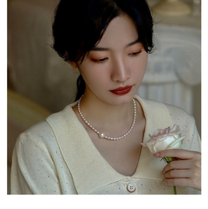 Macro shot of a vintage freshwater pearl necklace with gradient white pearls on neck