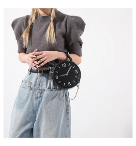 Creative black clock-shaped handbag with white numerals and a sleek metal chain strap