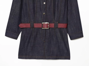 Detail of dark blue denim dress waist with a burgundy leather belt and silver buckle