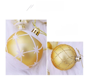 Close-up of golden Christmas ornaments with glitter grid and star patterns on white fur