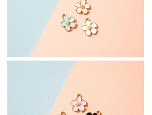 Detailed macro view of colorful enamel flower charms with golden metal alloy borders