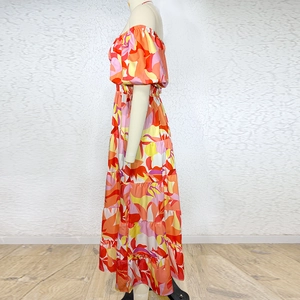 Detail of colorful floral print and puff sleeves on off-shoulder maxi vacation dress
