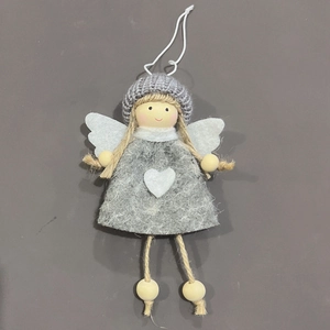 Detail of handmade angel ornament with gray knit hat and white heart on felt dress