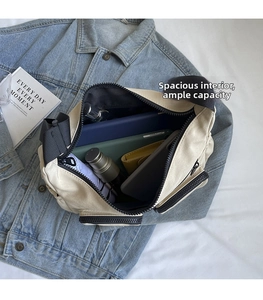 Internal storage view of the off-white canvas crossbody bag with multiple compartments