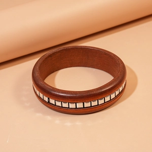 Detailed view of dark brown wood square bracelet with inlaid silver metal square patterns