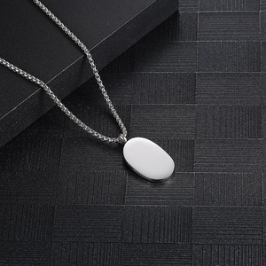 Dark style ghost necklace with silver oval pendant and box chain on black packaging