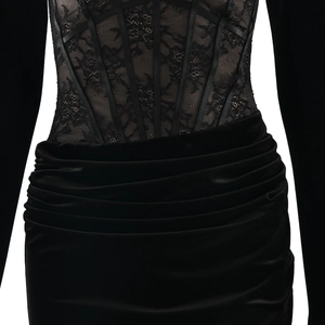 Detail of black lace corset waist and ruched velvet skirt texture on a long dress