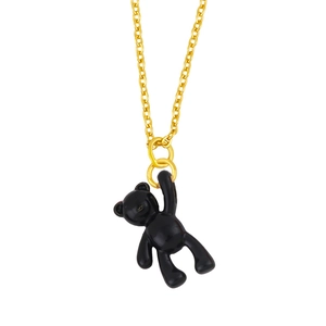 Macro detail of golden chain necklace with a 3D black enamel bear pendant for women