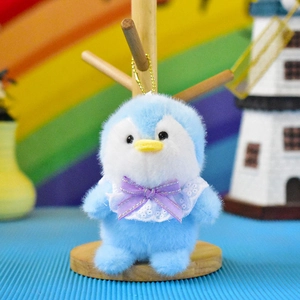 Detailed close-up view of a cute light blue plush penguin keychain with purple bow.