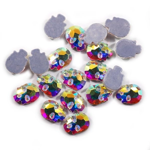 Detailed macro view of skull-shaped K9 iridescent crystals with flat gray backs