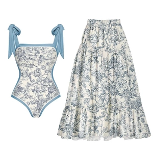 Detail of floral print one-piece swimsuit and matching long skirt with bow straps