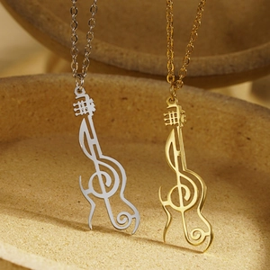 Creative music themed necklace featuring silver and gold guitar and treble clef pendants