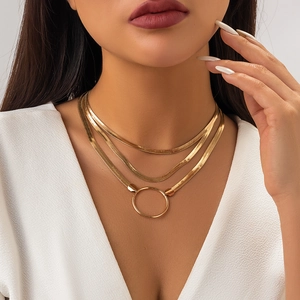 Close-up of golden triple-layered snake chain choker with a minimalist circular ring pendant