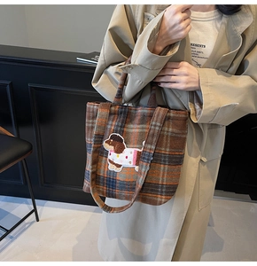 Detail of cute puppy embroidery on a brown plaid wool tote bag for women