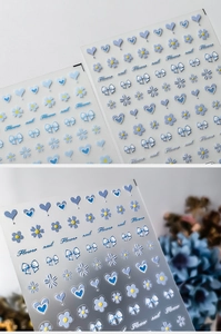 Macro detail of 3D embossed light blue nail stickers with flowers and bows on clear backing
