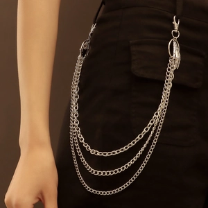 Close-up of triple-layer silver pants chain featuring a unique skeleton hand pendant detail