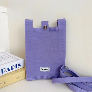 Detailed texture of lavender purple knit mobile phone bag with silver button and white label