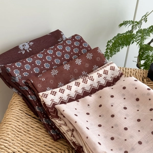 Floral and polka dot cotton linen neck scarves set displayed in a woven basket