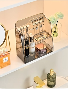Close-up of transparent gray acrylic organizer featuring top hooks and storage drawers