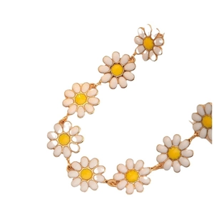 Elegant daisy floral charm bracelet with white enamel petals and golden metal details